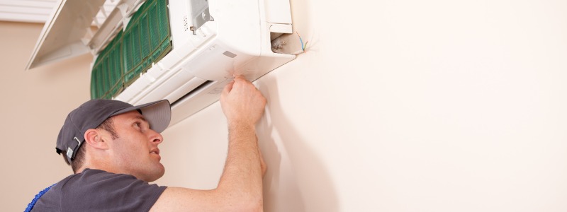 technician with ductless hvac system