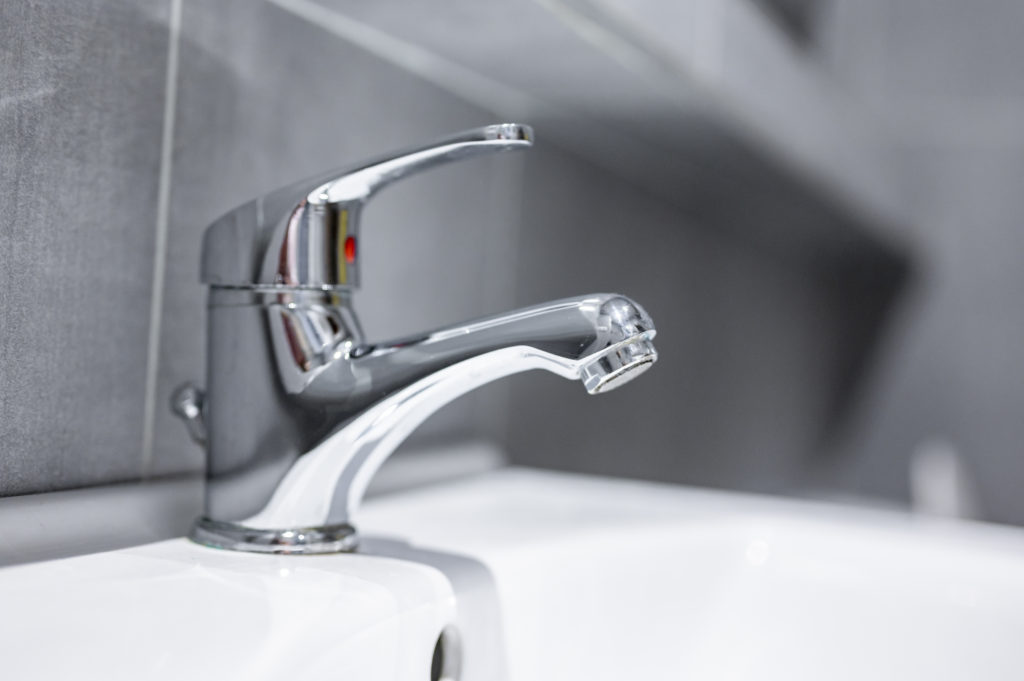 Water tap with ball faucet. Flow water in bathroom with sink