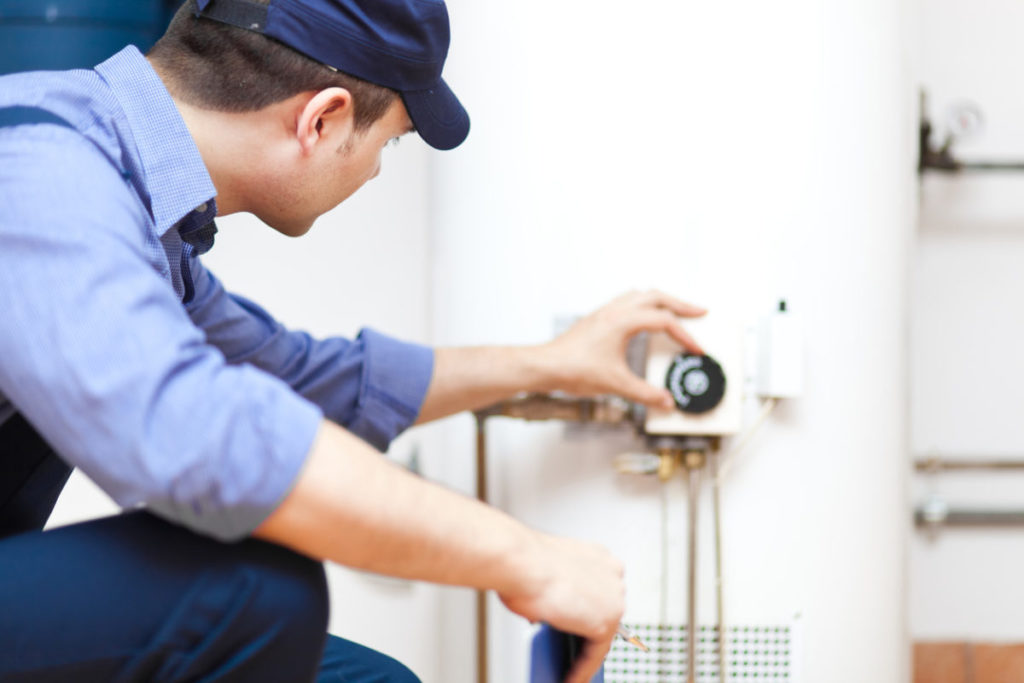 Plumber working on a water heater