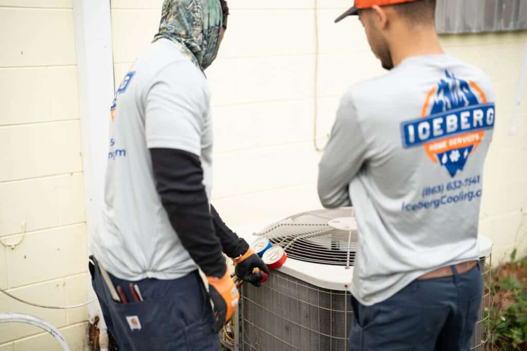 Iceberg Home Services technicians maintaining an air conditioner