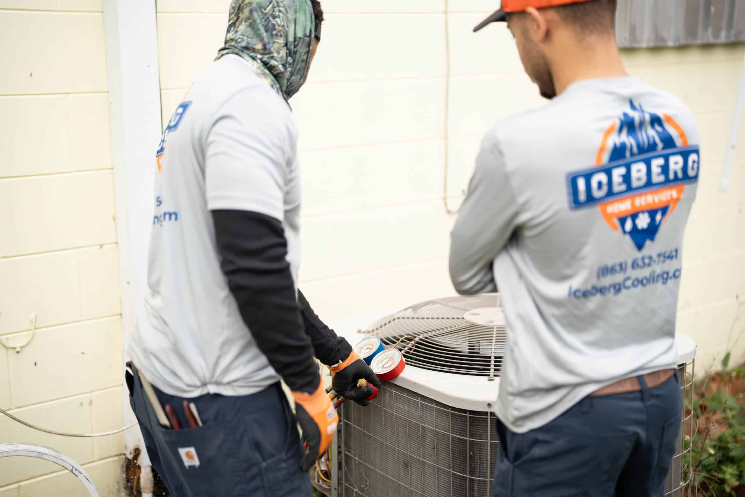 Iceberg technicians working on an ac unit