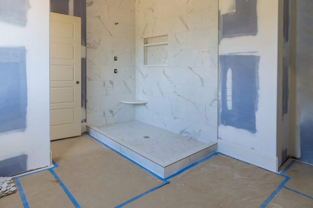 Bathroom in the process of being remodeled with floors removed and new drywall put up